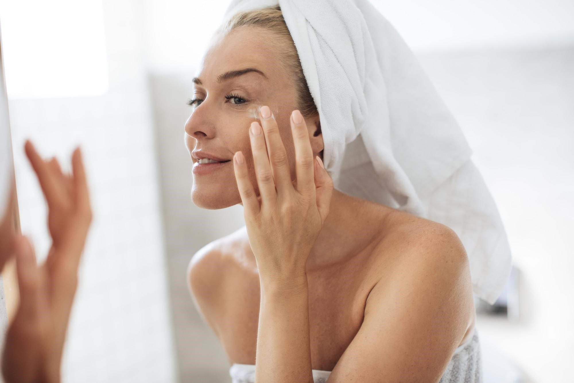 woman applying the Active Peel System from iS Clinical after a shower