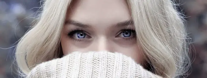 Attractive woman with fair skin hiding her lower face in her warm knit turtle neck - Prevent Dry Skin