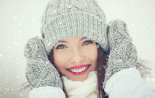 woman in winter with great skin and smile - winter skincare pro tips